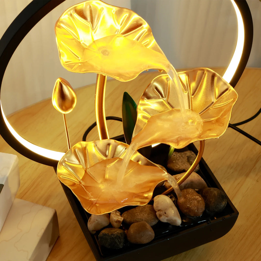 Warm light shines through the layered, leaf-shaped fountain.