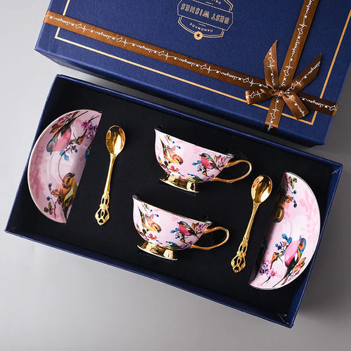 Bird-pattern cups, matching saucers and gold-tone spoons in a presentation box.